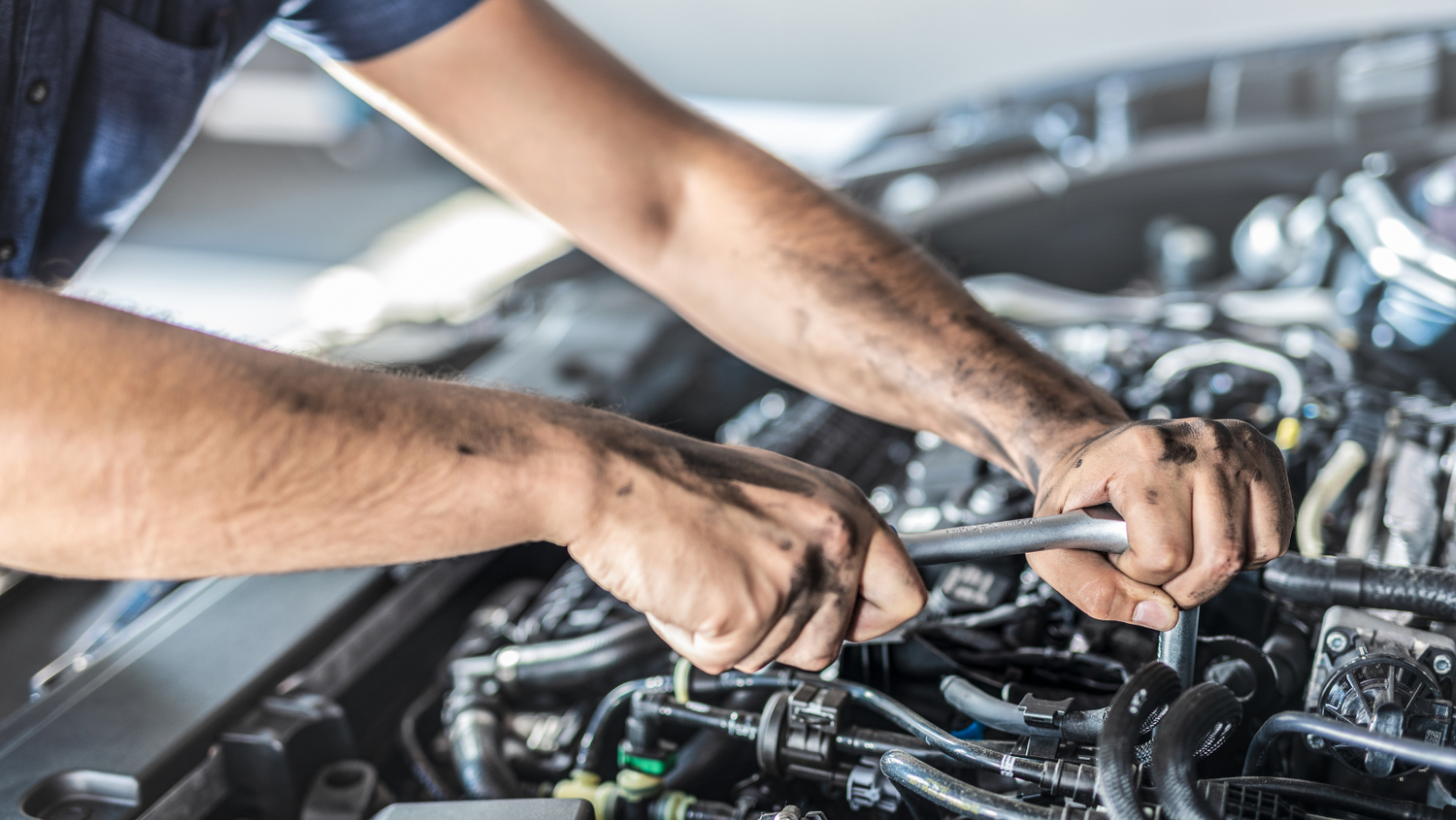 A mechanic fixing a car's engine